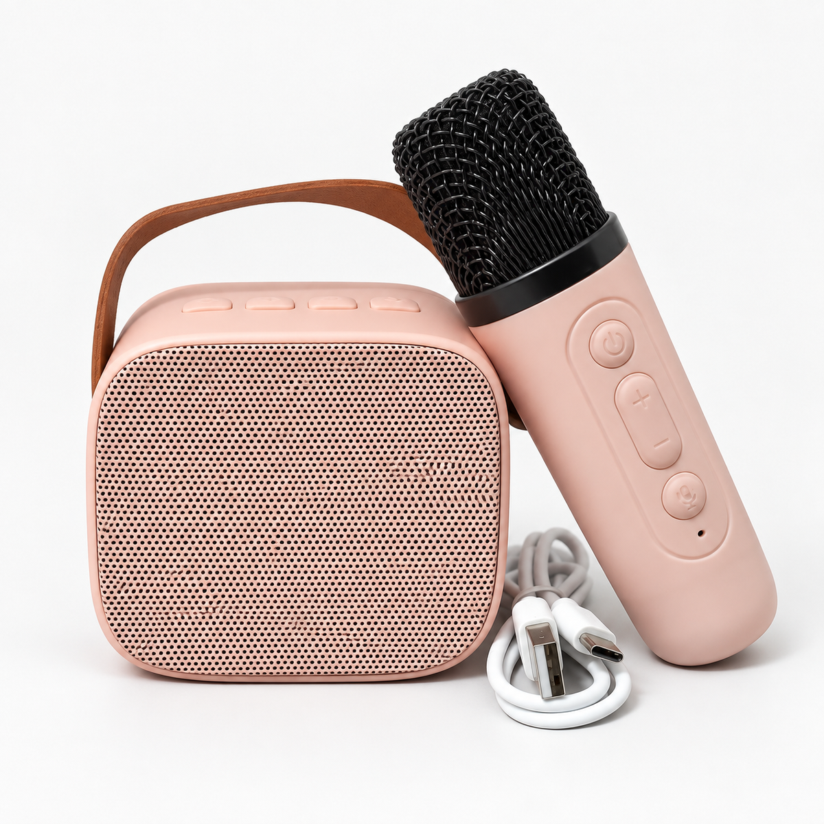 Mini karaoke speaker, handheld microphone and USB charging cable; Pink shown